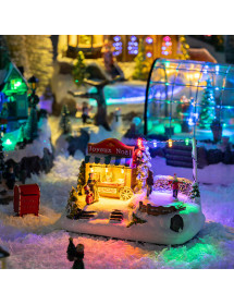 Village de Noël lumineux avec stand de chocolat et patinoire