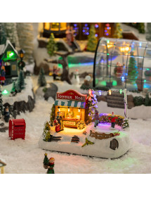 Village de Noël lumineux avec stand de chocolat et patinoire